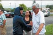 ??  ?? James Juncal, 17, greets Tracey Lazore and John Muracaon at Aqua Vino in Utica on Thursday, Aug. 16, 2018.