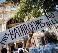  ?? NICK WAGNER / AMERICAN-STATESMAN ?? John Shanks holds up a sign as he joins a protest at the Capitol in July against Senate Bill 6, the so-called “bathroom bill.” The Legislatur­e was beginning its special session that day, and its efforts to pass the bill failed.