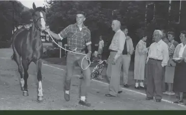  ??  ?? In 1956 when he was 15 years old, Emerson completed the Green Mountain Horse Associatio­n’s 100-mile trail ride with his horse Bonfire. Here the event’s head judge, Gen. Wayne Kester, DVM, evaluates Bonfire in South Woodstock, Vermont.