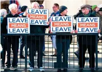  ?? AP ?? NO GOING BACK: Activists hold up placards from the Leave Means Leave Pro-Brexit campaign group outside the Houses of Parliament in London on Tuesday. —