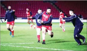  ?? AFP ?? Scarlets players warm up on the pitch ahead of the European Rugby Champions Cup Pool A rugby union match at Parc y Scarlets in Llanelli, south west Wales on Friday.