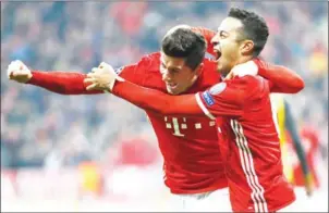  ?? AFP/ODD ANDERSEN ?? Bayern Munich’s Thiago Alcantara (right) celebrates scoring with Robert Lewandowsk­i in their Champions League match against Arsenal on Wednesday.