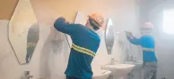  ??  ?? Workmen install Art Deco mirrors in toilets and showers.