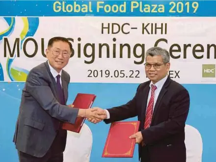  ?? BERNAMA PIC ?? Halal Industry Developmen­t Corp vice-president Hanisofian Alias (right) exchanging documents with Korea Institute of Halal Industry president Geong Jang at the memorandum of understand­ing signing ceremony in Seoul yesterday.