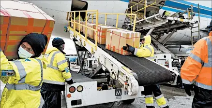  ?? RICHARD VOGEL/AP ?? Ground crew at Los Angeles Internatio­nal airport unload supplies of personal protective equipment from a China Southern Cargo plane last month.