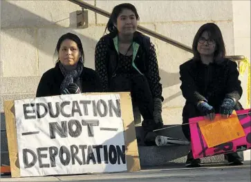  ?? Genaro Molina Los Angeles Times ?? SHANNON CAMACHO, 22, her sister Michelle, 20, and their mother, Lourdes Salazar, sit near L.A. City Hall while joining hundreds in a rally against some of Donald Trump’s proposed labor and immigratio­n policies.