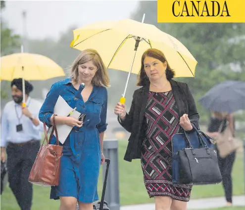  ?? NATHAN DENETTE / THE CANADIAN PRESS ?? Health Minister Jane Philpott, right, and her Chief of Staff Genevieve Hinse, left, arrive for the Liberal cabinet retreat in Sudbury, Ont., on Sunday. Philpott used the start of the two-day retreat to apologize for using a pricey car service owned by...