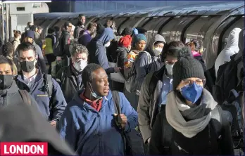 ??  ?? LONDON Morning commute: Undergroun­d rail passengers heading to work