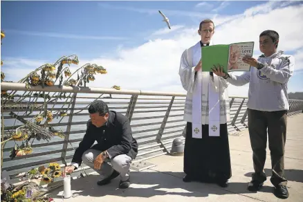  ?? JUSTIN SULLIVAN/GETTY IMAGES ARCHIVES ?? The Rev. Cameron Faller, associate pastor at the Church of the Epiphany, conducts a prayer service at the site where 32-year-old Kate Steinle was killed last year. According to police, Steinle was shot and killed by an undocument­ed immigrant who fired...