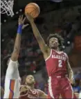  ?? RON IRBY — ASSOCIATED PRESS ?? Alabama guard Collin Sexton drives to the basket over Florida forward Dontay Bassett during the first half of a February game in Gainesvill­e, Fla.