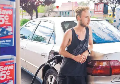  ?? MARLA BROSE/JOURNAL ?? Josh McArthur fills up his tank at Murphy Express on Carlisle NE. McArthur says he has to be more careful with his spending because of the recent rise in gasoline prices. “For a single college kid living on a fixed income, it sucks,” he said.