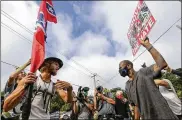  ?? ASSOCIATED PRESS ?? Protesters and counterpro­testers face off in Stone Mountain Village, Georgia. White supremacis­t propaganda reached alarming levels across the U.S. in 2020, according to a new report.