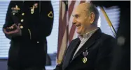  ?? ANDREW CRAFT/THE FAYETTEVIL­LE OBSERVER VIA AP ?? Oscar Davis Jr, a 92-year-old World War II veteran who served with the 1st Battalion, 505th Parachute Infantry Regiment, smiles Saturday after being awarded a Purple Heart medal for wounds suffered in Ardennes during the Battle of the Bulge.