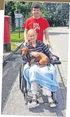  ?? ?? In recovery Jayne’s husband Steven pushes her and pet dog Cleveland around the hospital grounds