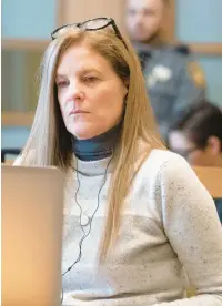  ?? RICHARD HARBUS/FOR DAILY MAIL.COM ?? Michelle Troconis reads a juror’s note and listens to Judge Kevin A. Randolph read the note in Stamford Superior Court on the sixth day of her criminal trial Friday.