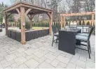  ??  ?? The fenced backyard is perfect for entertaini­ng, with a huge stone patio with a gazebo and an outdoor kitchen.