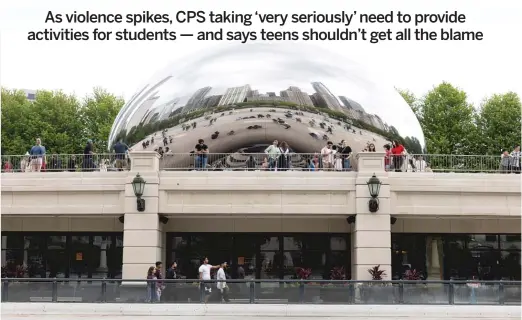  ?? ANTHONY VAZQUEZ/SUN-TIMES ?? Crowds flock to “The Bean” on Sunday, a day after a 16-year-old CPS student was fatally shot near the iconic attraction at Millennium Park.