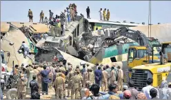  ?? AP ?? Soldiers and volunteers work at the site of a train collision in the Ghotki district in Pakistan, on Monday. Two express trains collided early Monday, killing at least 40 passengers, authoritie­s said, as rescuers and villagers worked to pull injured people.