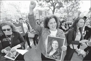  ?? Al Seib Los Angeles Times ?? ALISA BLAIR, a deputy public defender, center, protests L.A. County supervisor­s’ appointmen­t of Nicole Davis Tinkham, who has never tried a criminal case, as interim public defender during a rally in Grand Park.