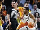  ?? WADE PAYNE — THE ASSOCIATED PRESS ?? Vanderbilt’s Jordan Wright, right, drives against Tennessee’s Santiago Vescovi during the first half on Wednesday in Nashville, Tenn.