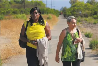  ?? Photos by Peggy Peattie / Special to The Chronicle ?? Milena Phillips (left) walks with Maria Keever on a San Diego bike path. The women’s sons were slain by Scott Thomas Erskine, a San Quentin State Prison inmate who died of COVID19.