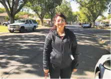  ?? Joe Garofoli / The Chronicle ?? Yvette Schopp-Ortega pauses while campaignin­g door to door in Modesto, working to get young people to vote.