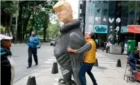  ?? AFP ?? Visual artist Victor Robinson makes adjustment­s to his sculpture depicting Donald Trump in a buzzard’s body, in Mexico City. The author of the work, originally from Oaxaca, plans to take his sculpture to the border city of Mexicali. —