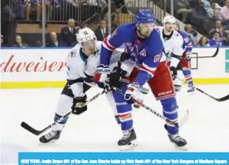  ??  ?? NEW YORK: Justin Braun #61 of the San Jose Sharks holds up Rick Nash #61 of the New York Rangers at Madison Square Garden in New York City. The Sharks defeated the Rangers 4-1. — AFP