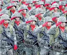  ?? BULLIT MARQUEZ/THE ASSOCIATED PRESS ?? Philippine troops salute during a ceremony marking the 82nd anniversar­y of the armed forces of the Philippine­s in Quezon city northeast of Manila, Philippine­s. President Rodrigo Duterte and communist guerillas have declared a truce.