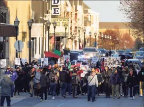  ?? Paul Sancya / Associated Press ?? Protesters march on Sunday in Kenosha, Wis. Kyle Rittenhous­e was acquitted of all charges after pleading self-defense in the deadly Kenosha shootings that became a flashpoint in the nation’s debate over guns, vigilantis­m and racial injustice.