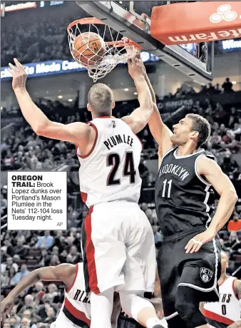  ??  ?? OREGON TRAIL: Brook Lopez dunks over Portland’s Mason Plumlee in the Nets’ 112-104 loss Tuesday night.