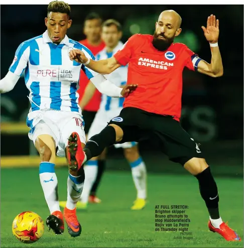  ?? PICTURE: Action Images ?? AT FULL STRETCH: Brighton skipper Bruno attempts to stop Huddersfie­ld’s Rajiv van La Parra on Thursday night