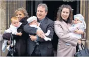  ??  ?? Three of a kind: the triplets are christened at St Nicholas Church, Newbury, with Esther Ranzen, left