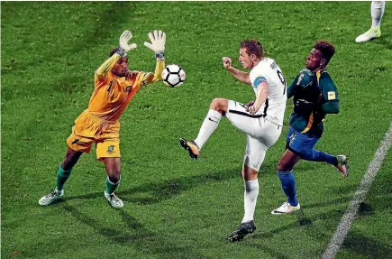  ?? GETTY IMAGES ?? Chris Wood tries to shoot past Solomon Islands goalkeeper Phillip Mango on Friday night.