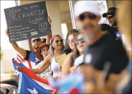  ?? Tom Fox Dallas Morning News ?? PUERTO RICANS in Texas call for the resignatio­n of Gov. Ricardo Rossello, who has faced protests over leaked messages with sexist and disparagin­g comments.