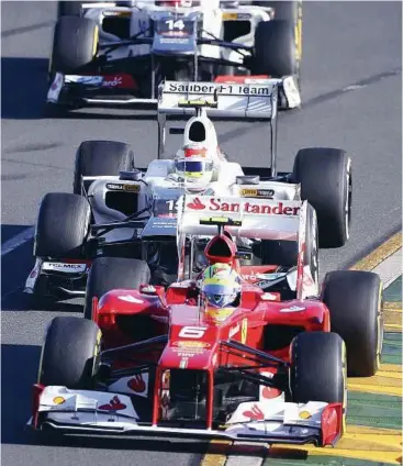  ??  ?? Disastrous start: Brazilian Felipe Massa (front) is under pressure to improve his form at Ferrari after being over a second slower than his team-mate Fernando Alonso during the Australian Grand Prix. – AP