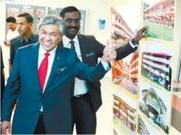  ??  ?? Ahmad Zahid and Deputy Education Minister P. Kamalanath­an viewing a display at an exhibition during an event yesterday to present special allocation­s to Tamil schools.