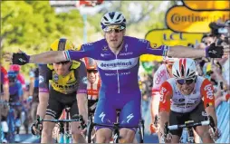  ?? Christophe Ena The Associated Press ?? Italy’s Elia Viviani celebrates as he crosses the finish line to win the 133-mile fourth stage of the Tour de France on Tuesday in Nancy, France.