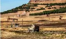  ??  ?? A US military armoured vehicle drives in a patrol past a an oil well in Rumaylan in Syria’s northeaste­rn Hasakeh province. Photograph: Delil Souleiman/AFP via Getty Images