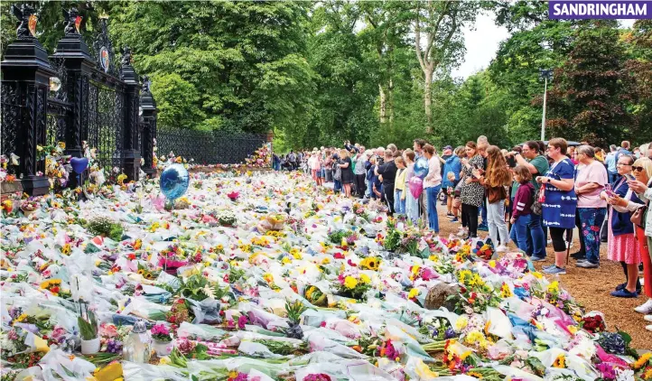  ?? SANDRINGHA­M ?? Flowers fit for a Queen: Bouquets and balloons spread out like a carpet outside Norwich Gates, where the floral display had grown to 30ft deep by the afternoon