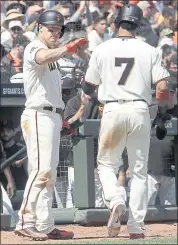  ?? JEFF CHIU — THE ASSOCIATED PRESS ?? The Giants’ Gorkys Hernandez (7) is congratula­ted by Nick Hundley after scoring against the Pittsburgh Pirates during the sixth inning on Sunday at AT&amp;T Park.