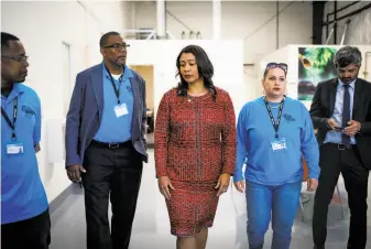  ?? Gabrielle Lurie / The Chronicle ?? Mayor London Breed (center) tours the new Bayshore Navigation Center the day after the election in which key items on her political agenda were defeated at the polls.