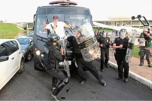  ?? Crowd control: ?? Riot police arresting a demonstrat­or after a group invaded the Chamber of Deputies in Brasilia, Brazil. — EPA