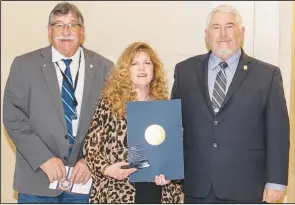  ?? Photo by Tricia Pemberton ?? Rep. Rick West, left, and Sen. George Burns, right, presented Carl Albert State College Power I Program Director Ramona Smith with a citation at the State Capitol recognizin­g her Making It Work Day Spotlight Award on Monday at the State Capitol by the Oklahoma Career and Technical Education Equity Council.