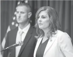  ?? The Dallas Morning News/TNS ?? ■ U.S. Attorney Erin Nealy Cox announces federal charges against 57 white supremacis­t gang members Monday at the Earle Cabell Federal Building in Dallas. Captain Phillip Fuller of the Texas Department of Public Safety is at left.