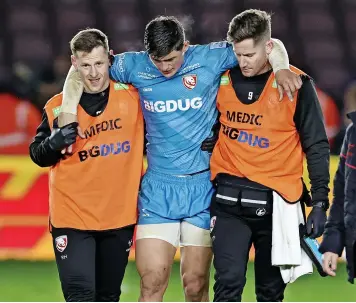  ?? ?? Louis Reeszammit is helped off the pitch after being injured against Harlequins