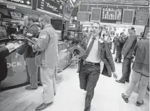  ?? Michael Nagle / Bloomberg ?? Traders on the floor of the New York Stock Exchange have been busy during recent market gains in which CEOs of top companies have seen their stock holdings jump in value.