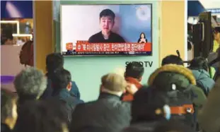  ??  ?? Commuters at a railway station in Seoul yesterday watching news on television showing a video of a man claiming to be Kim Jong-Nam’s son, Han-Sol.