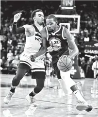  ??  ?? SCORING LEADER. Golden State Warriors’ Kevin Durant (35) drives the ball as Minnesota Timberwolv­es’ Tyus Jones defends during the second half of an NBA basketball game Friday, Nov. 2, 2018, in Oakland, Calif. AP