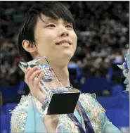  ?? EUGENE HOSHIKO — THE ASSOCIATED PRESS ?? Champion Yuzuru Hanyu reacts after the men’s victory ceremony of the Japan Figure Skating Championsh­ips Sunday during which he nearly landed a quadruple axel.